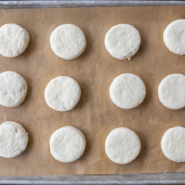 Biscuits on a baking sheet unbaked.