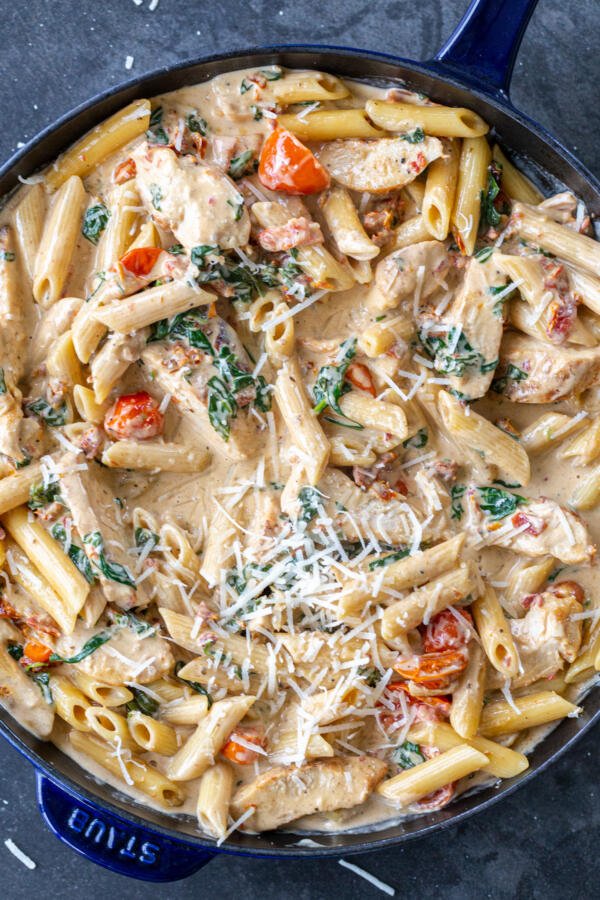 Creamy Tuscan Chicken Pasta in a pan.