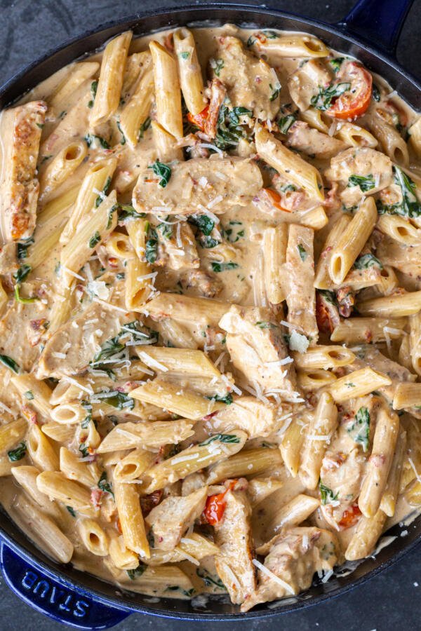 Creamy Tuscan Chicken Pasta in a pan.