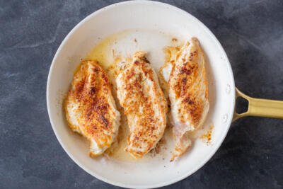 Cooking chicken in a pan.