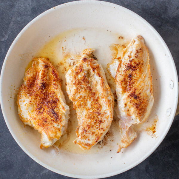 Cooking chicken in a pan.