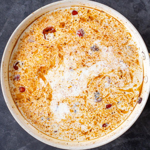 Heavy cream added to the pan.