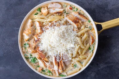 All the Creamy Tuscan Chicken Pasta ingredients in a pan.