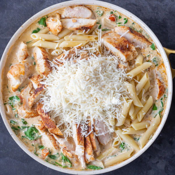 All the Creamy Tuscan Chicken Pasta ingredients in a pan.