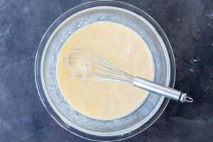 Eggs, milk and half and half in a bowl.