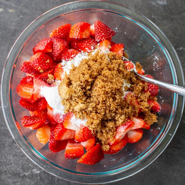 Strawberry cobbler filling ingredients in a bowl.