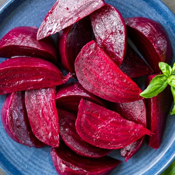 Sliced cooked beets on a plate.
