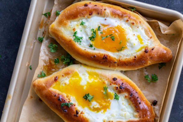 Pan with Khachapuri and herbs on top..