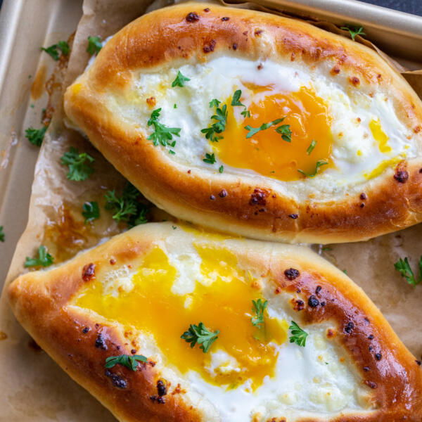 Pan with Khachapuri and herbs on top..