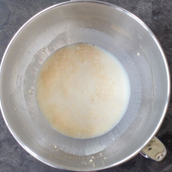 Liquids with yeast in a mixing bowl.