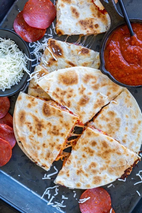 SLiced Pizza Quesadilla on a serving tray. 