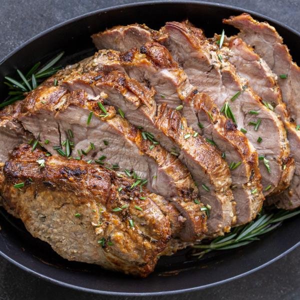 Sliced pork shoulder chop on a pan.