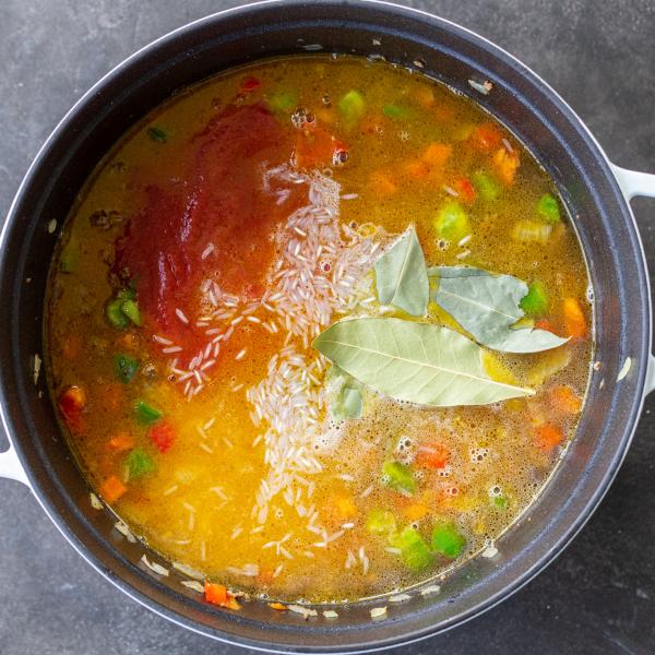 Liquids added to the veggies and meat in stuffed pepper soup.