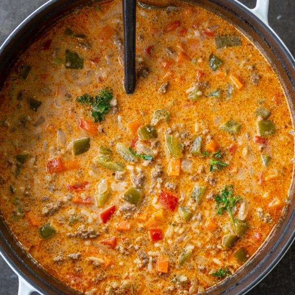 Stuffed Peppers Soup in a pot with a spoon.