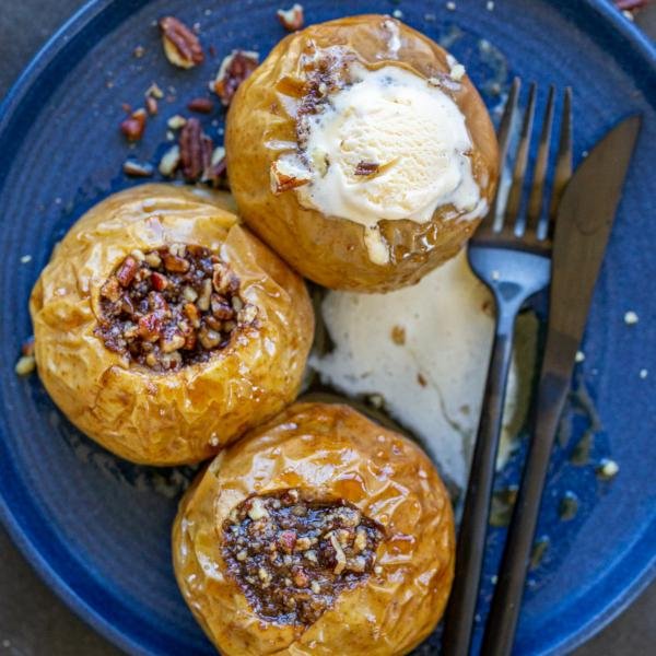 Baked Apples with ice cream and utensils.