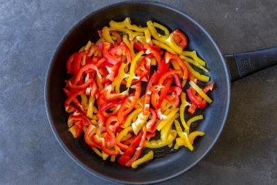 Bell peppers in a skillet.