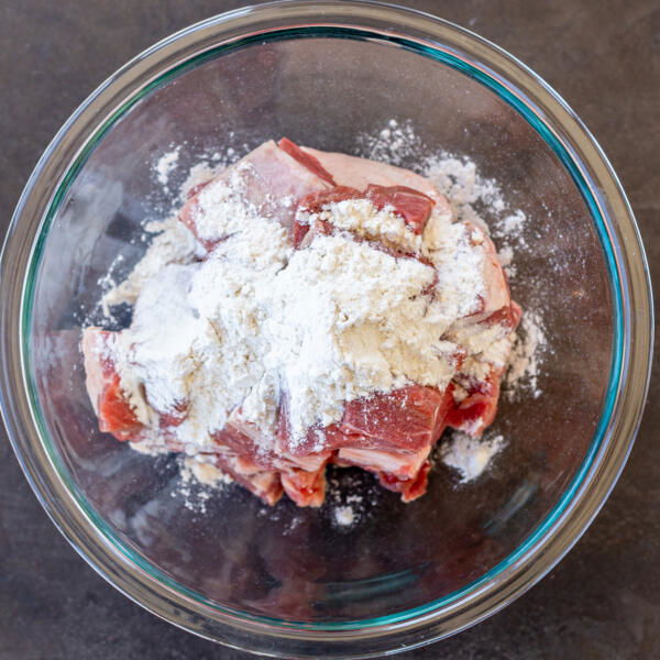 Lamb with flour in a bowl.