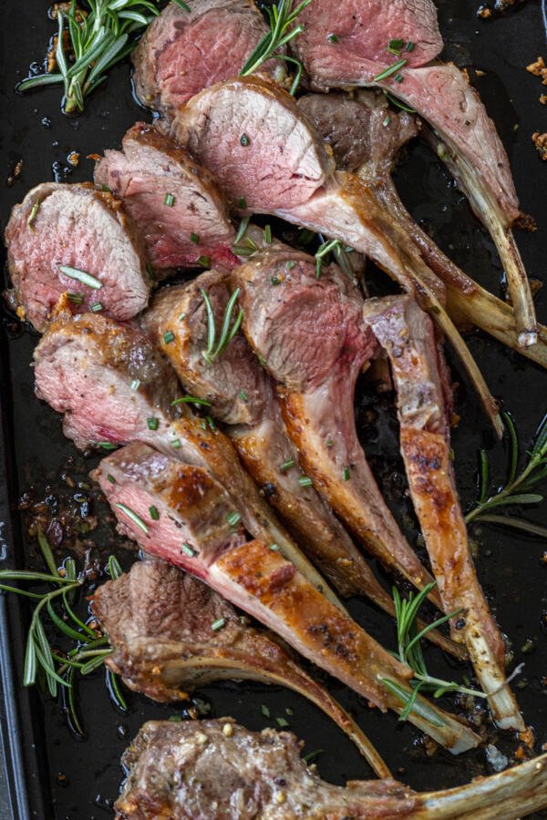 Roasted Rack of Lamb with herbs on a tray. 