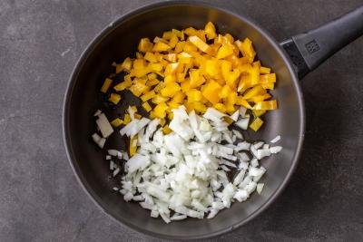 Bell pepper and onion in a pan.