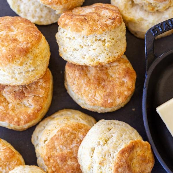 Sourdough Biscuits with butter in a dish next to it.