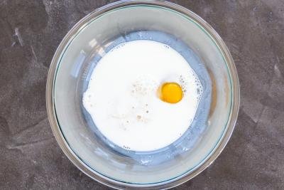Milk, egg and a starter in a bowl.