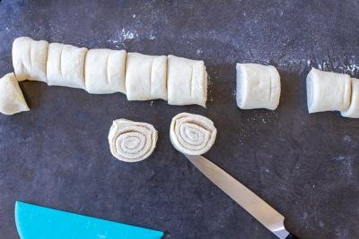 Rolled up cinnamon rolls dough cut into pieces.