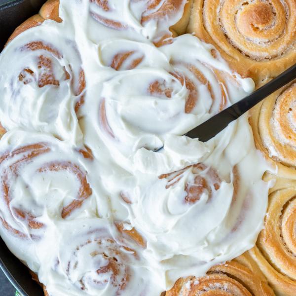Applied cream cheese to the cinnamon rolls.