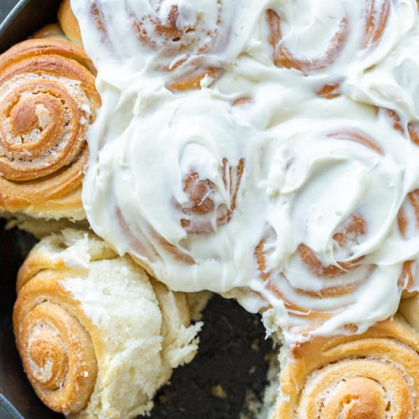 Cinnamon rolls topped with cream cheese frosting.