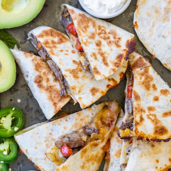 Steak Quesadilla with veggies and dippings.