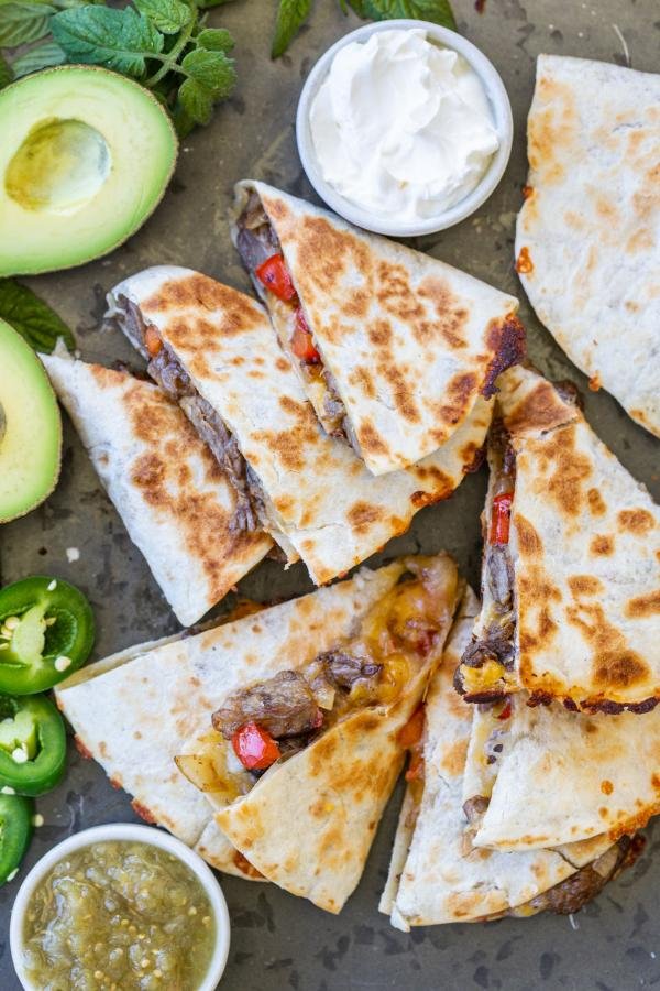Steak Quesadilla with veggies and dippings. 