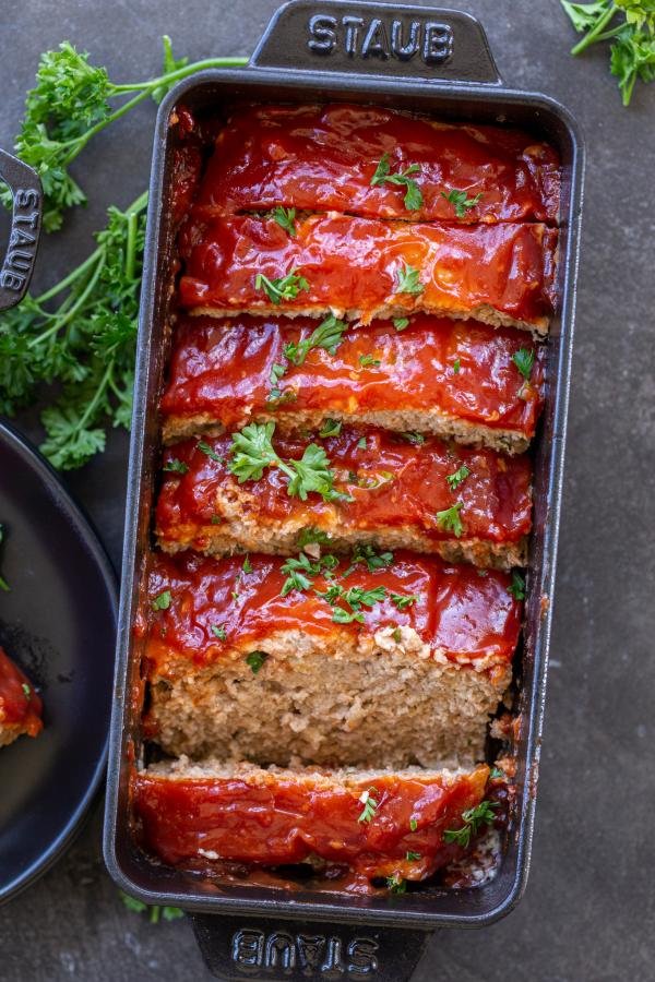 Sliced up turkey meatloaf in a pan.