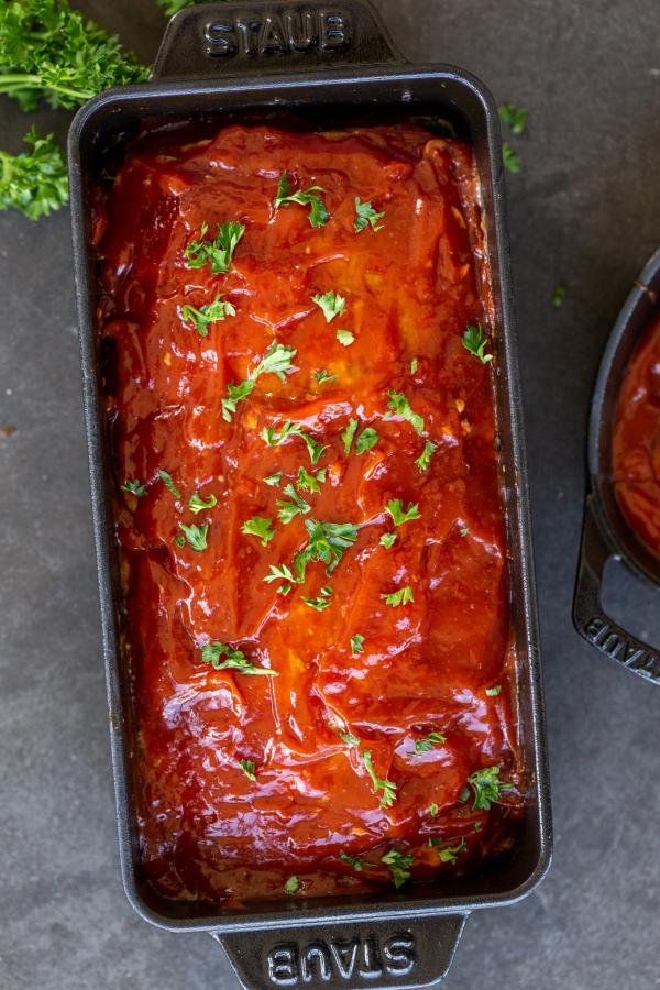 Turkey meatloaf in a pan with herbs.