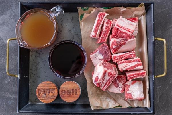 Ingredients for beef short ribs in a slow cooker.