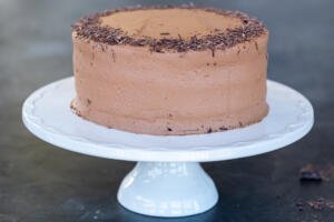 Boozy Chocolate Liqueur cake on a cake stand.