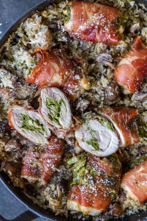 Rice with mushrooms and Prosciutto Wrapped Chicken in a pan. 