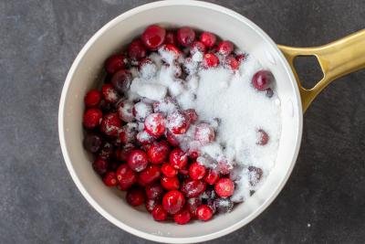 Cranberries with sugar in a pot.