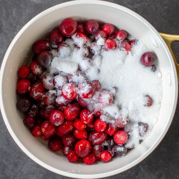 Cranberries with sugar in a pot.