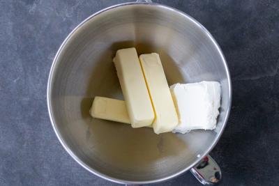 Butter and cream cheese in a mixing bowl.