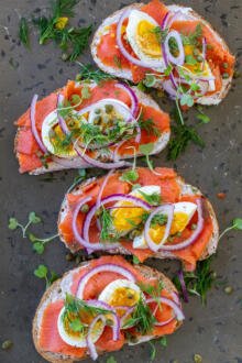 Smoked salmon toasts on a serving tray.