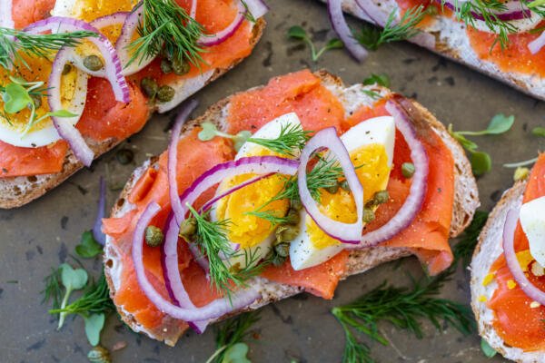 Smoked salmon toast with egg, onion and herbs.