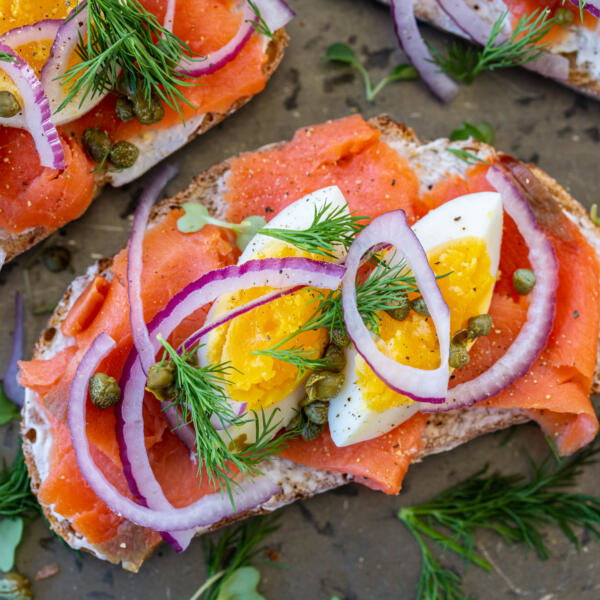 Smoked salmon toast with egg, onion and herbs.
