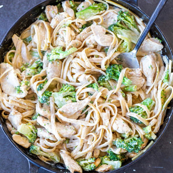 Chicken Broccoli Alfredo in a pan with a spoon.
