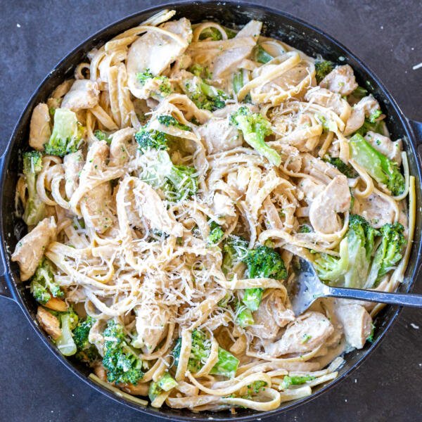 Chicken Broccoli Alfredo in a pan with a spoon.