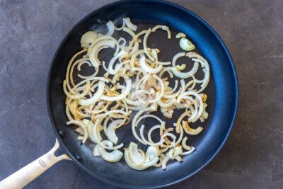 Onion browning in a frying pan.