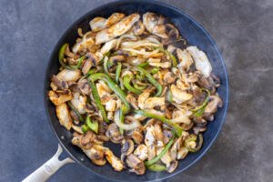 Veggies and chicken in a pan.