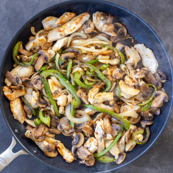 Veggies and chicken in a pan.