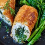 Chicken Kiev on a plate with asparagus.