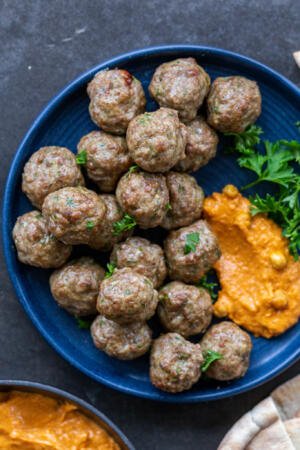Lamb Meatballs on a plate with herbs.