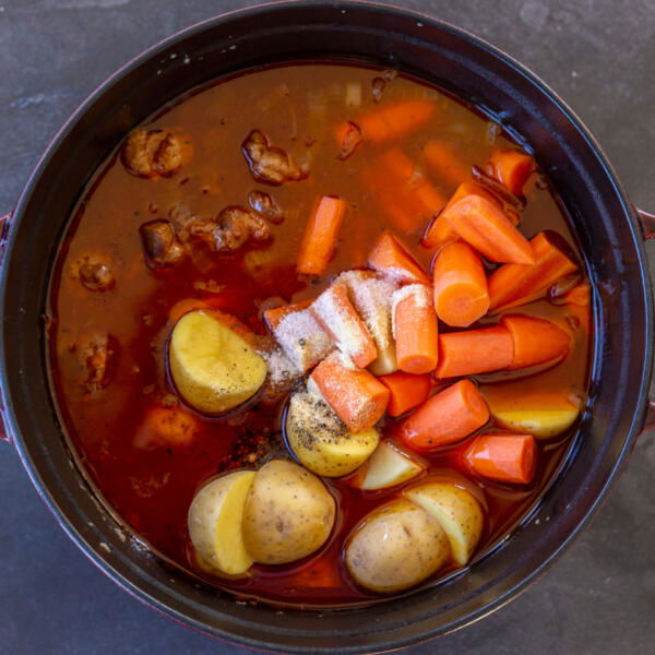 Carrots and potatoes added to the pot.