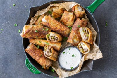 Philly Cheesesteak Egg Rolls with ranch sauce.